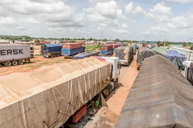 Camions bloqués à la frontière entre le Bénin et le Niger, illustrant les conséquences économiques de la fermeture